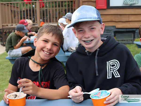 Campers enjoy ice cream on the lawn at Camp Menominee
